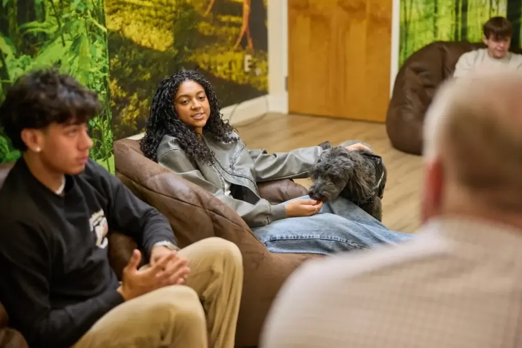 teen participating joyfully in a portum wellness group therapy session